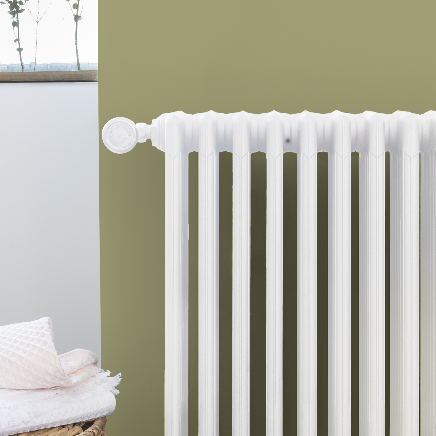 V33 Radiator Paint in White Satin on a painted radiator in a modern interior setting.