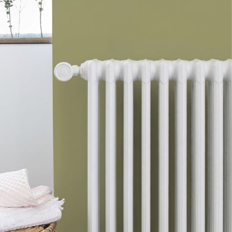 V33 Radiator Paint in White Satin on a painted radiator in a modern interior setting.